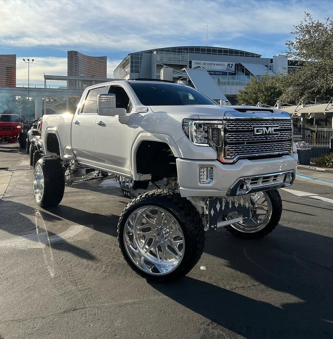 White lifted GMC Denali at SEMA on Specialty Forged wheels